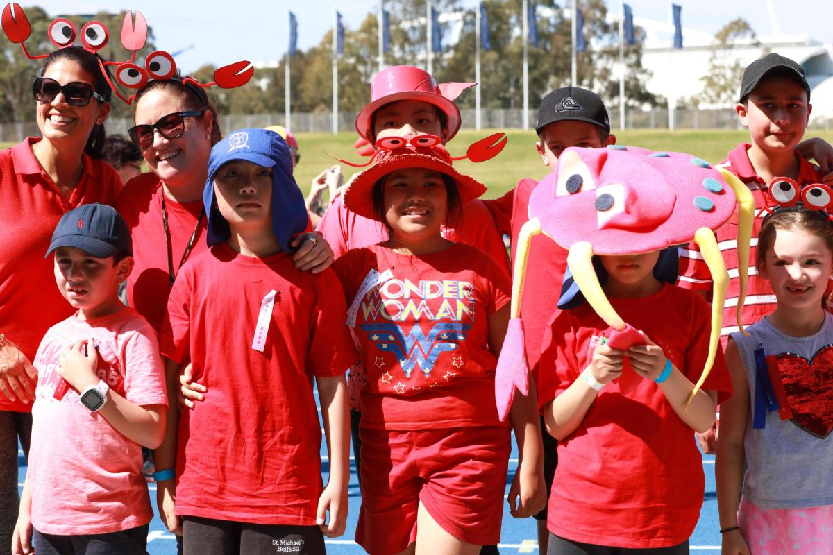 Students and adults walk around the staium showing their support for South East Sydney at Sports Carnival 2018